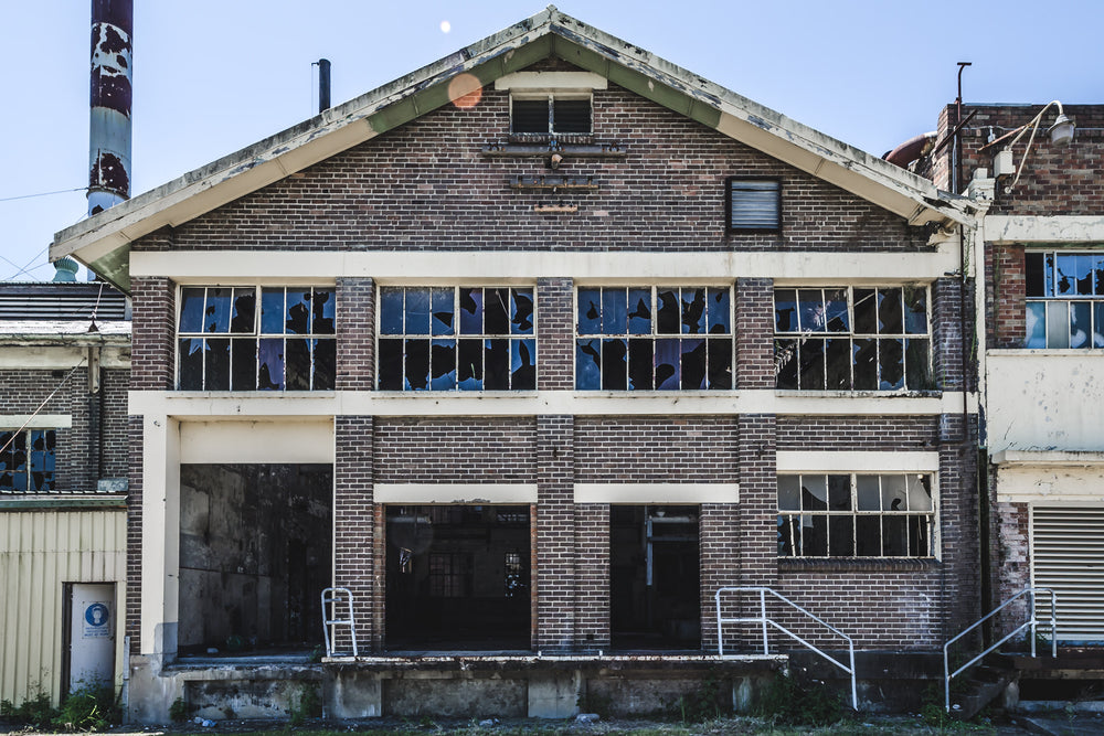 Boiler House Facade at Peters Ice Cream Factory, two storeys of brown brick and concrete banding, squared off under a gabled roofline.