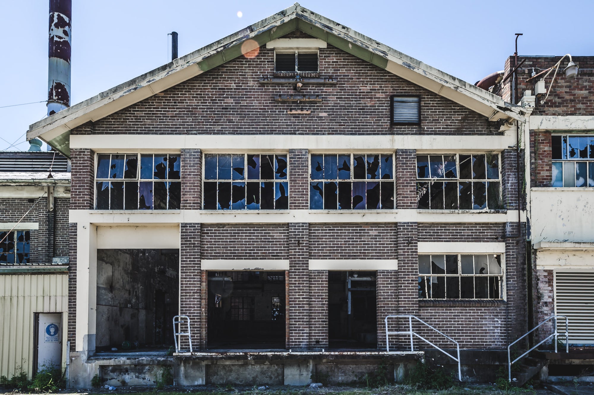Boiler House Facade at Peters Ice Cream Factory, two storeys of brown brick and concrete banding, squared off under a gabled roofline.