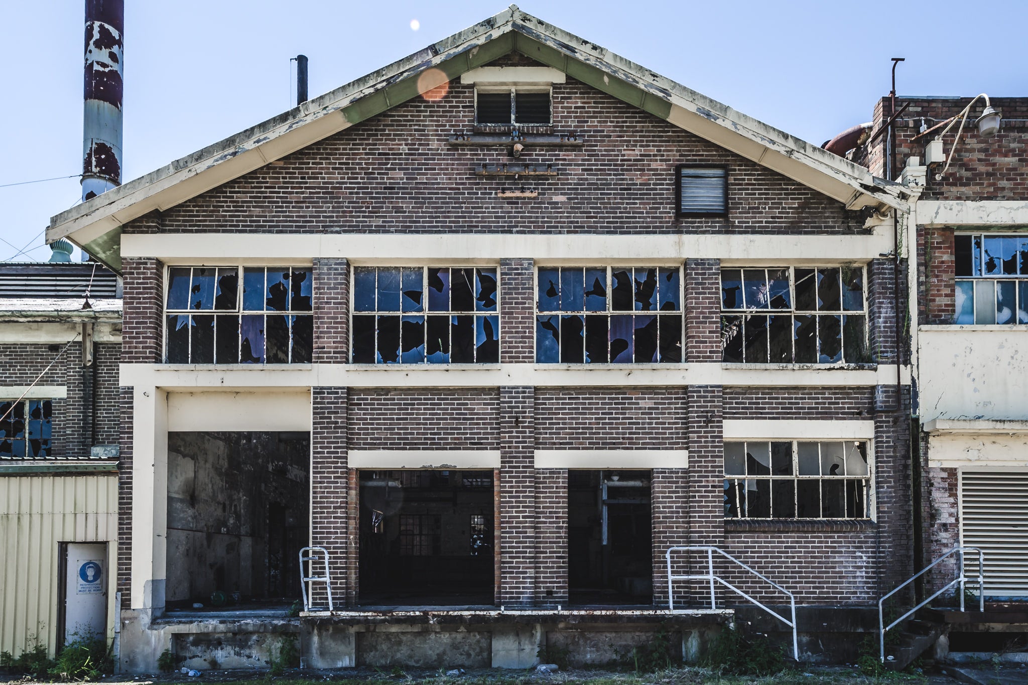 Boiler House Facade at Peters Ice Cream Factory, two storeys of brown brick and concrete banding, squared off under a gabled roofline.