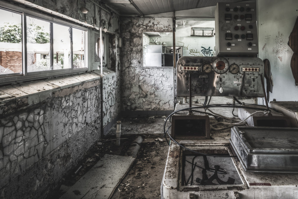 Laboratory at Peters Ice Cream Factory, a control panel sits bolted to the right wall, its gauges and dials still intact.