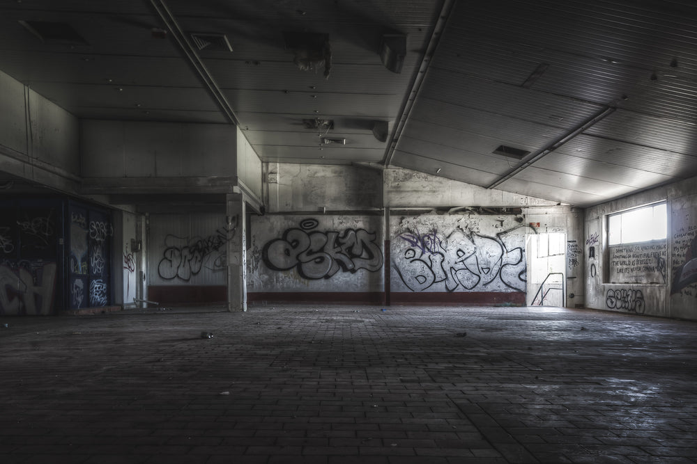 Production Packaging Room at Peters Ice Cream Factory, a wide commercial floor stretches out under a low corrugated metal ceiling.