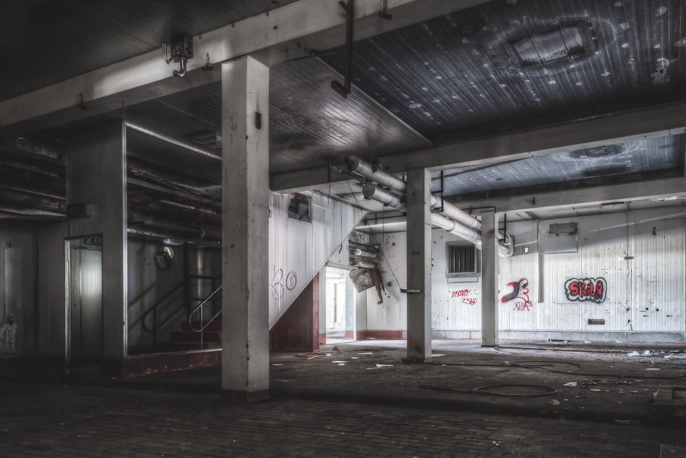 Raw Material Procesing at Peters Ice Cream Factory, concrete columns hold a low ceiling over a broad processing floor.