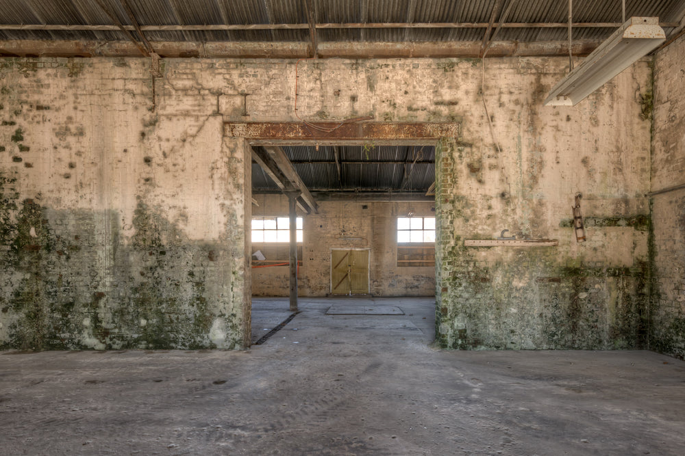 Blacksmith To Electrical Workshops at Portland Cement Works, a wide doorway cuts through a thick brick wall, connecting two.