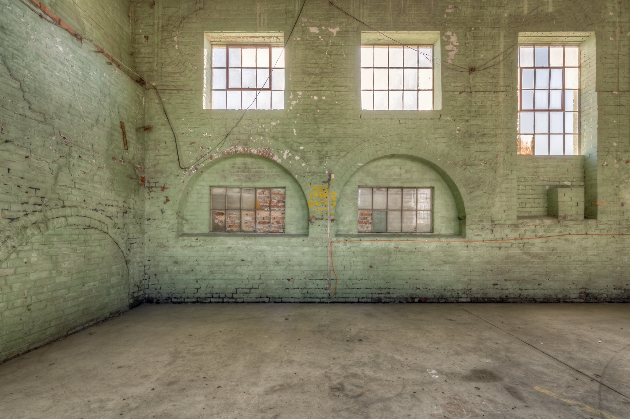Boiler House Flues at Portland Cement Works, green-painted brick rises two storeys high.