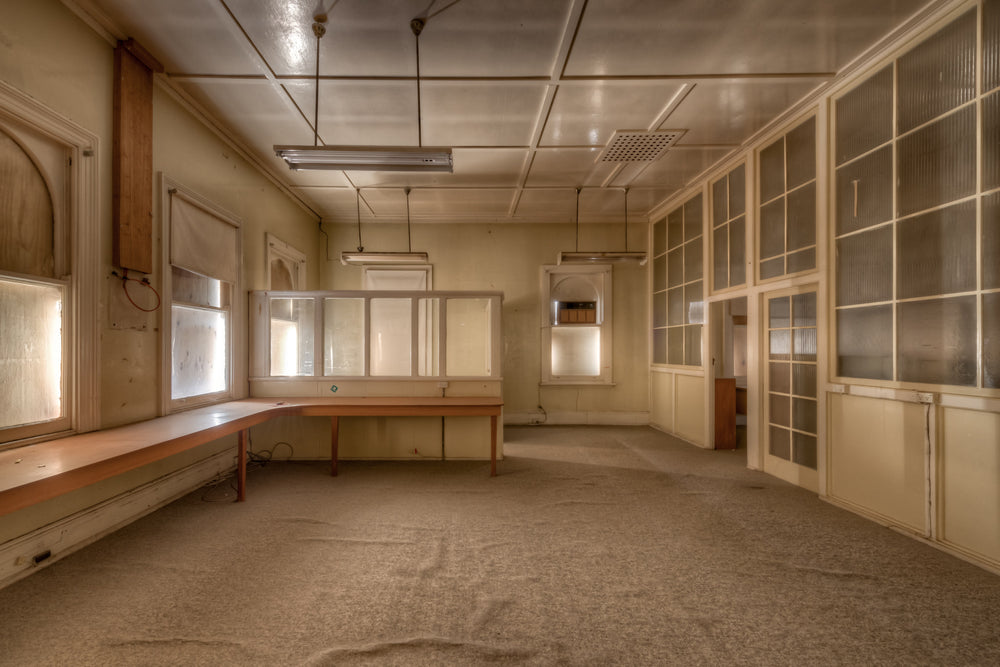 Drawing Office at Portland Cement Works, a long timber bench runs the length of the left wall, its surface bare.