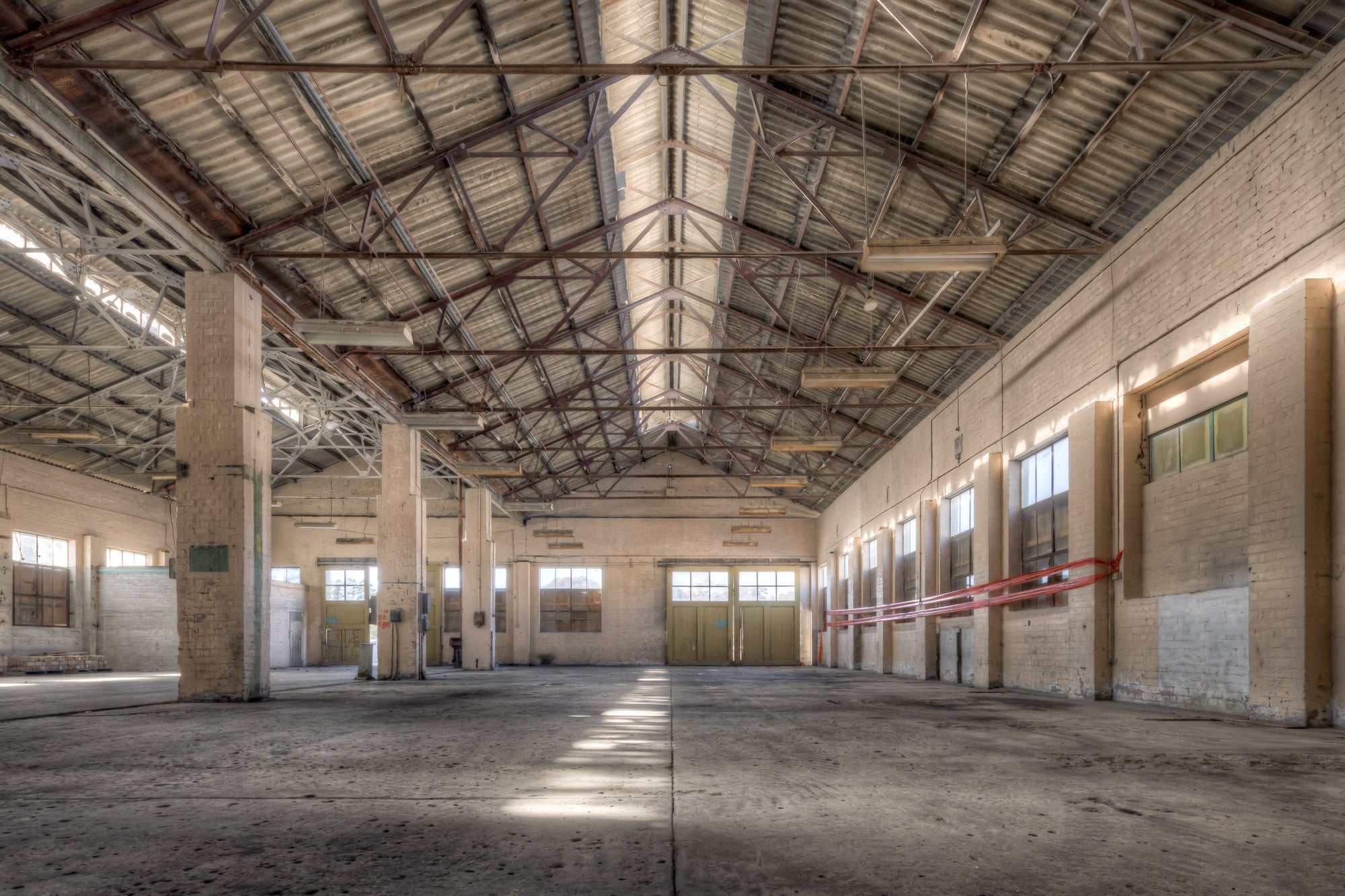 Machining Workshop at Portland Cement Works, steel roof trusses span the full width of the machining workshop, their bolted.