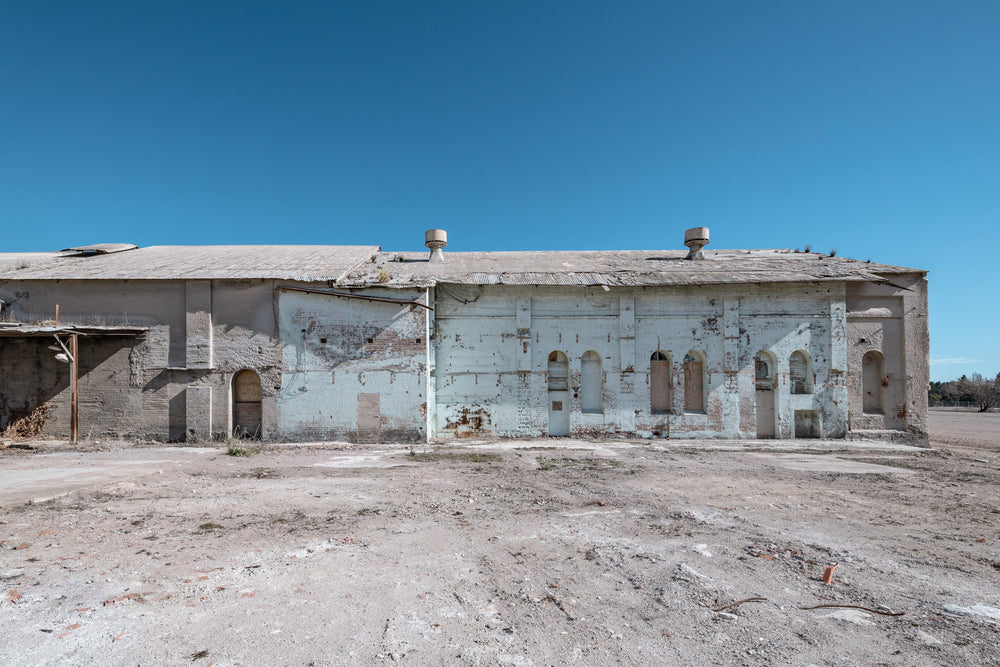Power House East Facing Exterior at Portland Cement Works, the east-facing wall of the power house stands pale against hard.
