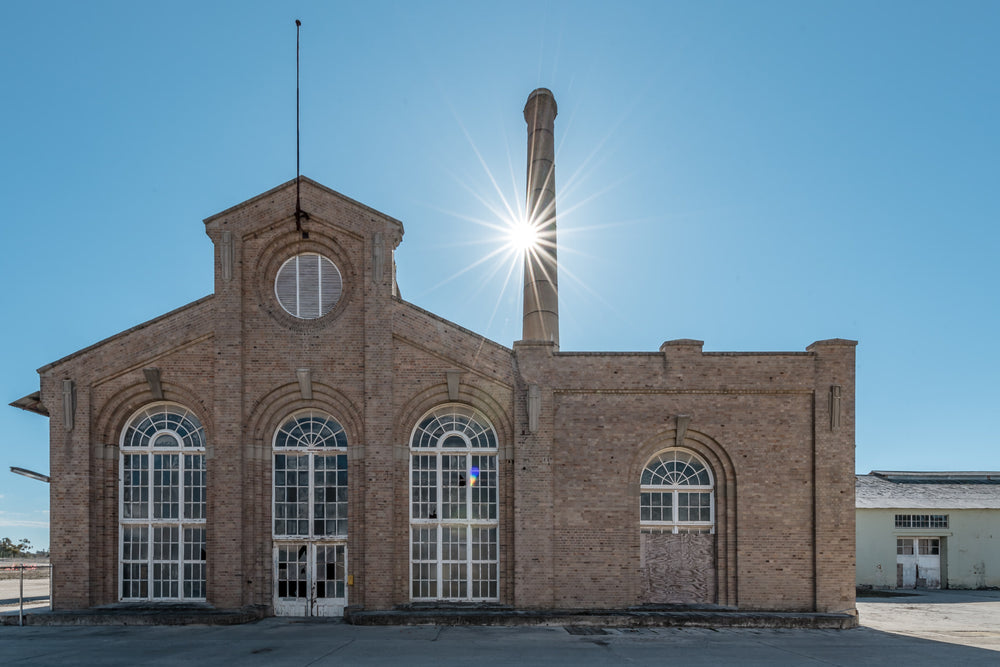Power House Exterior at Portland Cement Works, the power house at Portland Cement Works stands in full sun against a clear.