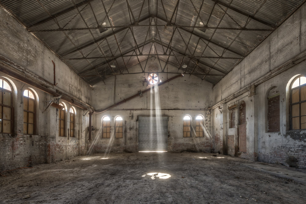 Power House Northern Interior at Portland Cement Works, a single beam of light falls from a roof ventilator and strikes.
