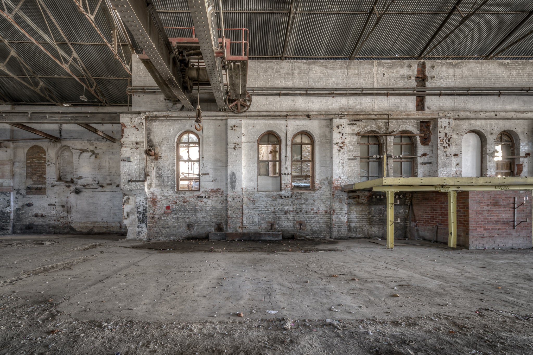 Power House Platform at Portland Cement Works, an overhead crane rail runs the length of the hall, its rusted hoist.