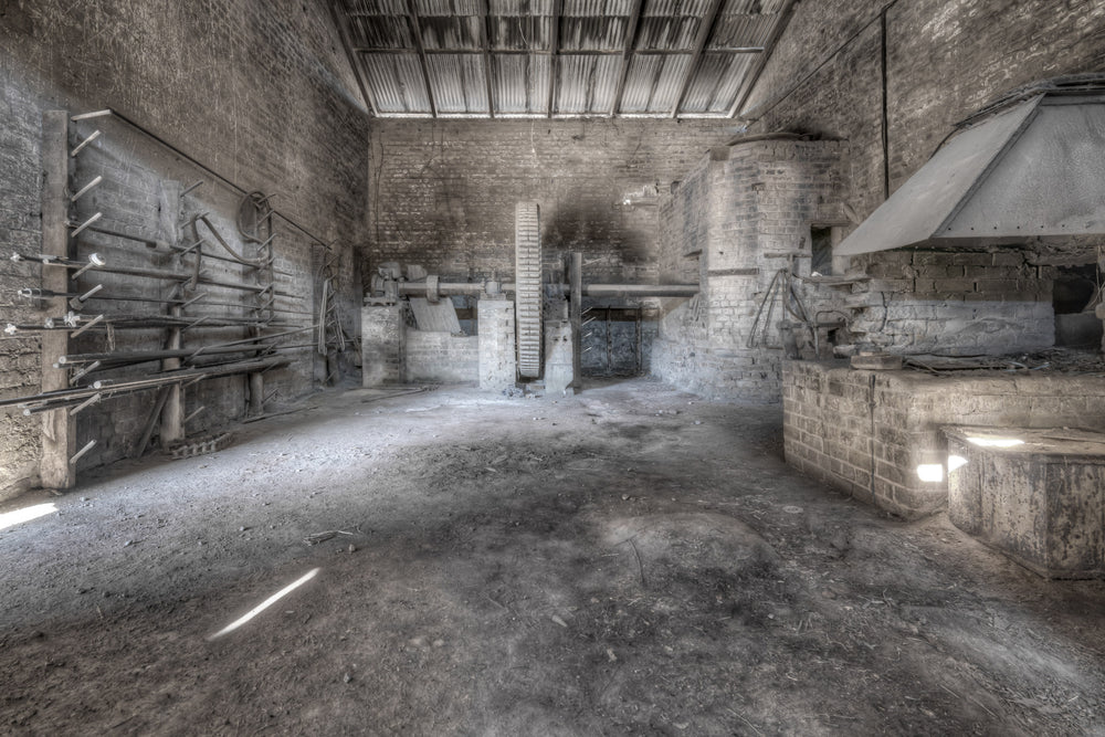 Raffan Mill at Portland Cement Works, bare brick walls rise to a corrugated iron roof inside one of the mill buildings.