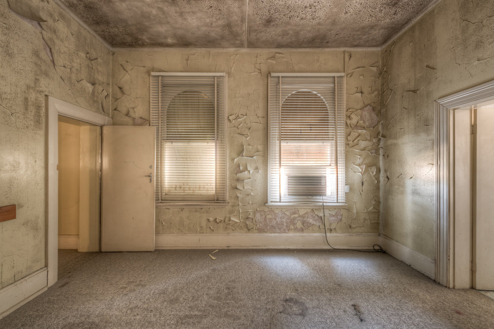 Supervisors Office at Portland Cement Works, two arched windows filter pale light through venetian blinds.