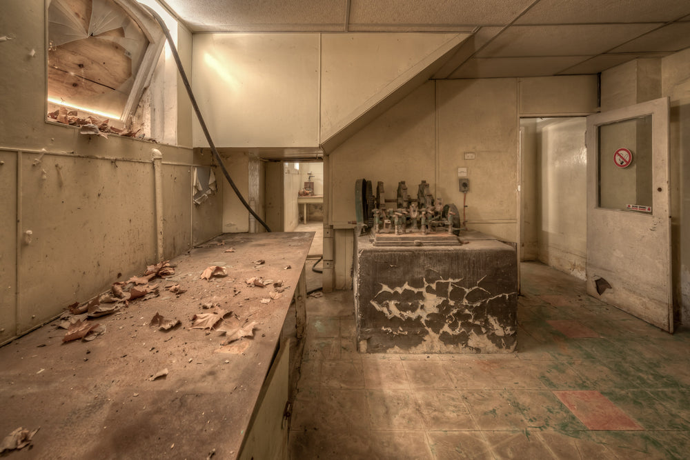 Testing Room at Portland Cement Works, a concrete bench runs the length of the room, covered in curled paint flakes.