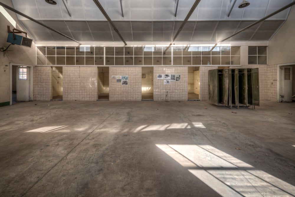 Wash House at Portland Cement Works, sunlight falls in clean geometric shapes across a concrete floor.