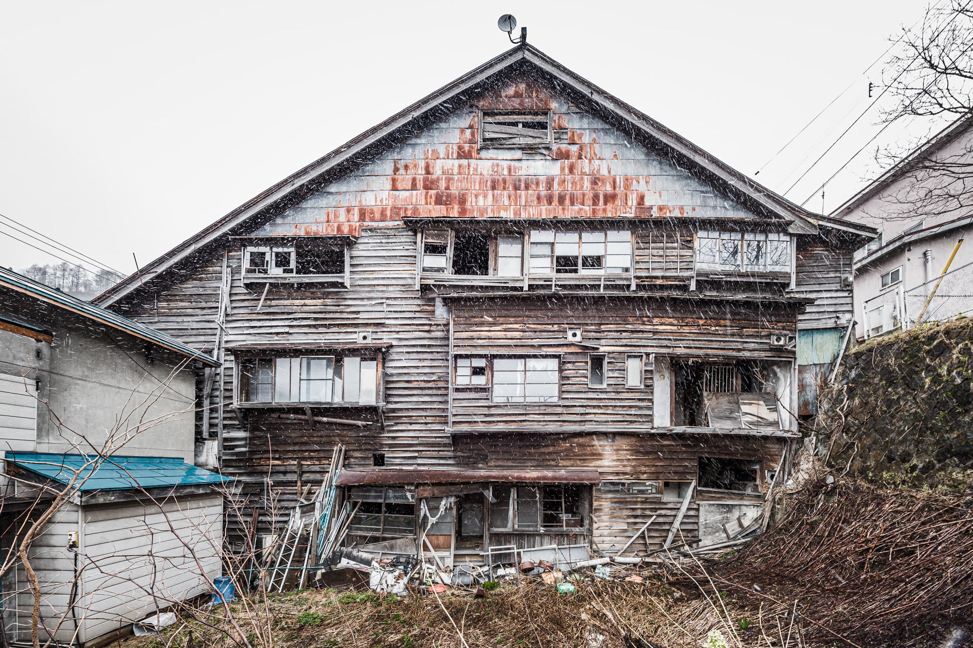 Side Facade at Streetscapes of Yubari, a shot from the side if an unstable building which would have once been a busy.