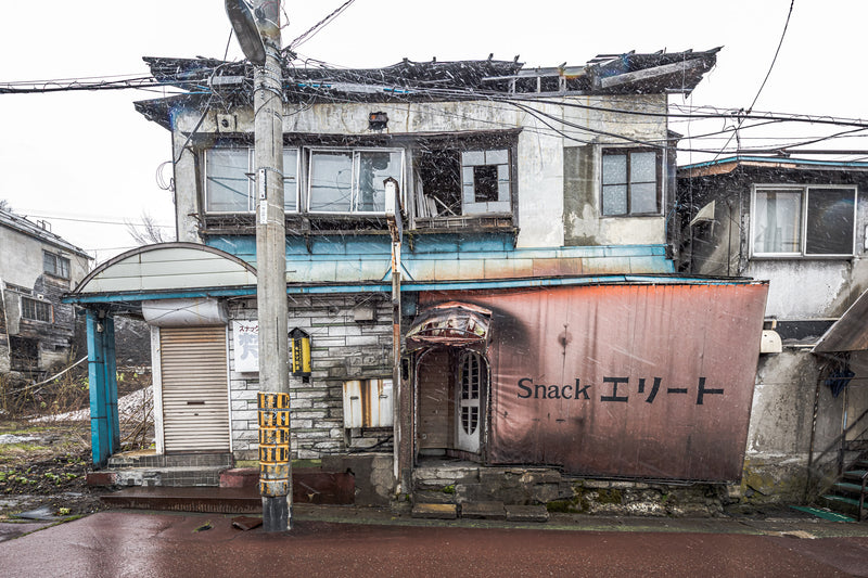 Snack Bar Elite at Streetscapes of Yubari, the roof of the building has collapsed under the weight of the snow build up.