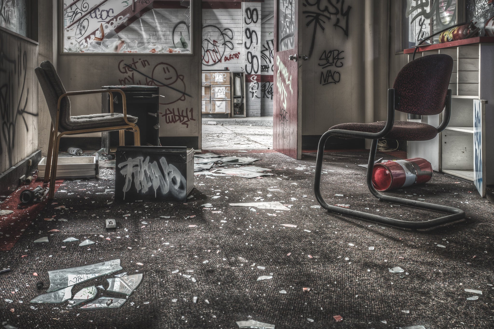 Consultation Room at Sundell Holden, two cantilever office chairs sit among broken glass and scattered debris.