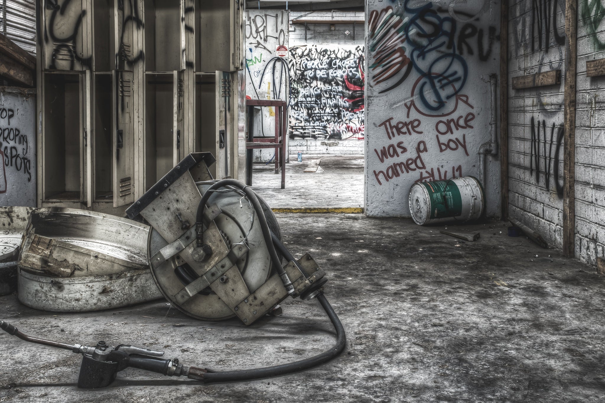 Grease Gun at Sundell Holden, an old grease gun reel left in a waste oil area.
