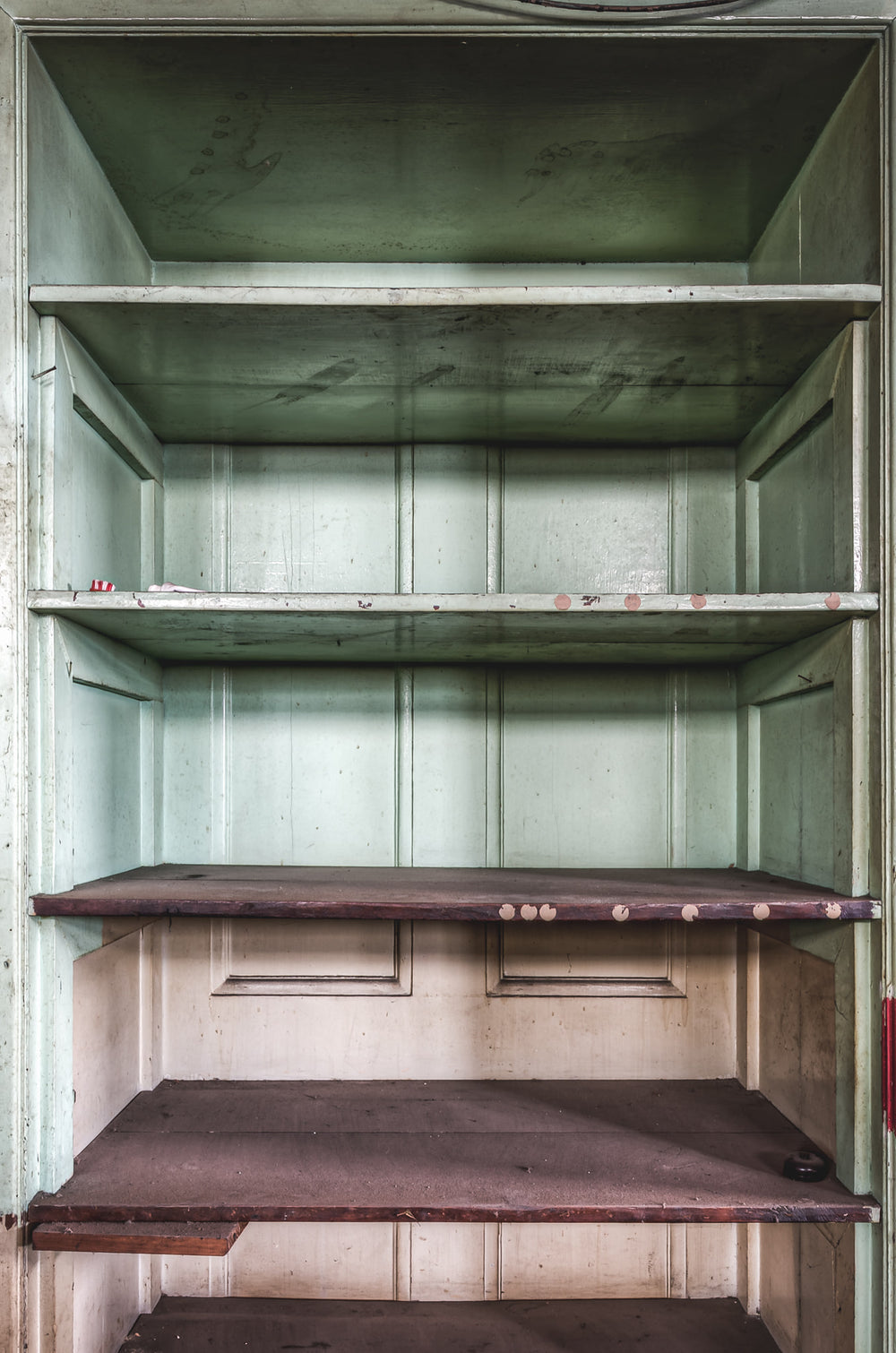 Bar Shelving at Terminus Hotel, a built-in timber cabinet sits behind the bar, its doors open.