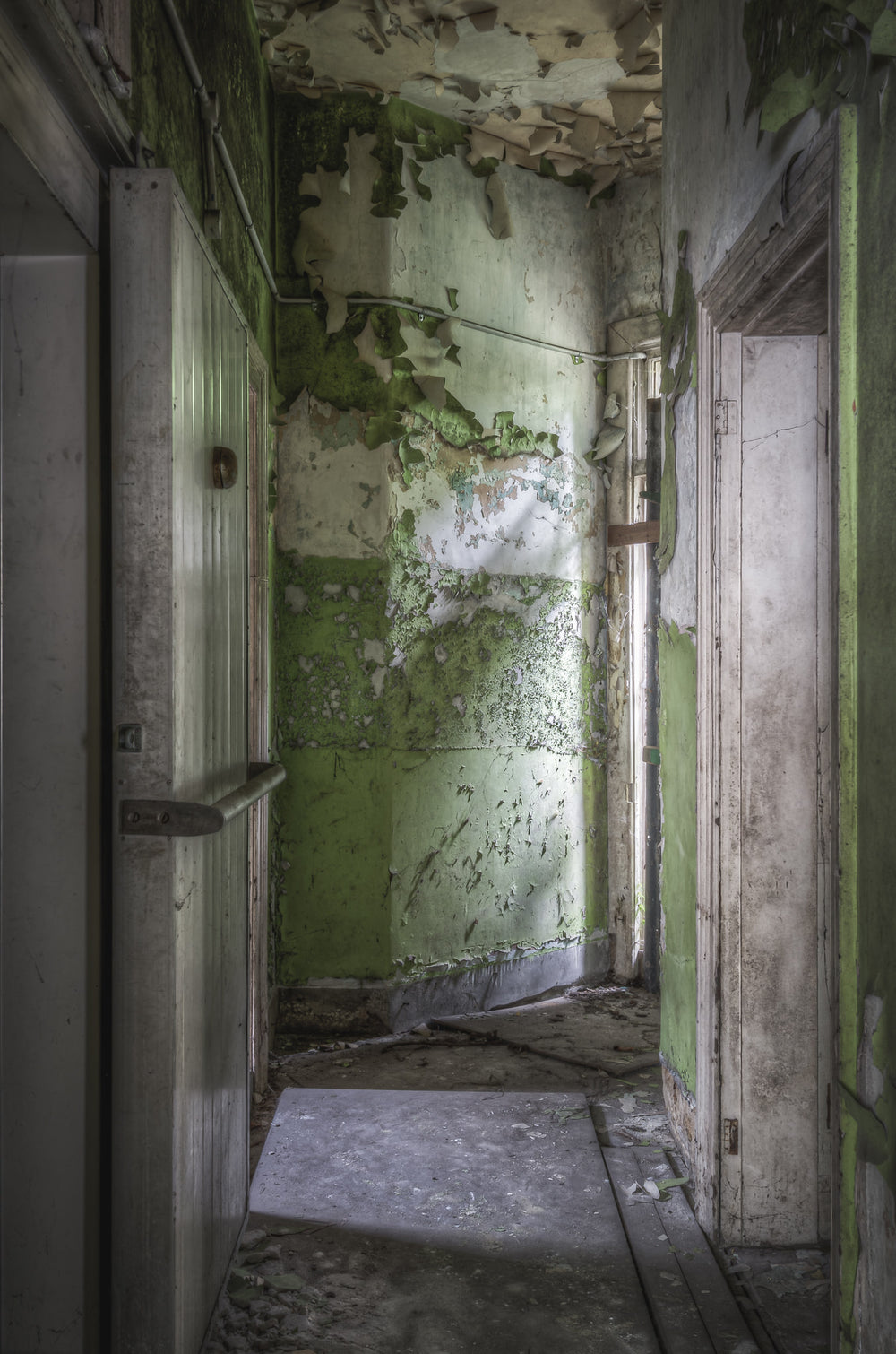 Cold Storage at Terminus Hotel, light cuts across the floor in a quiet diagonal, illuminating years of dust and decay.