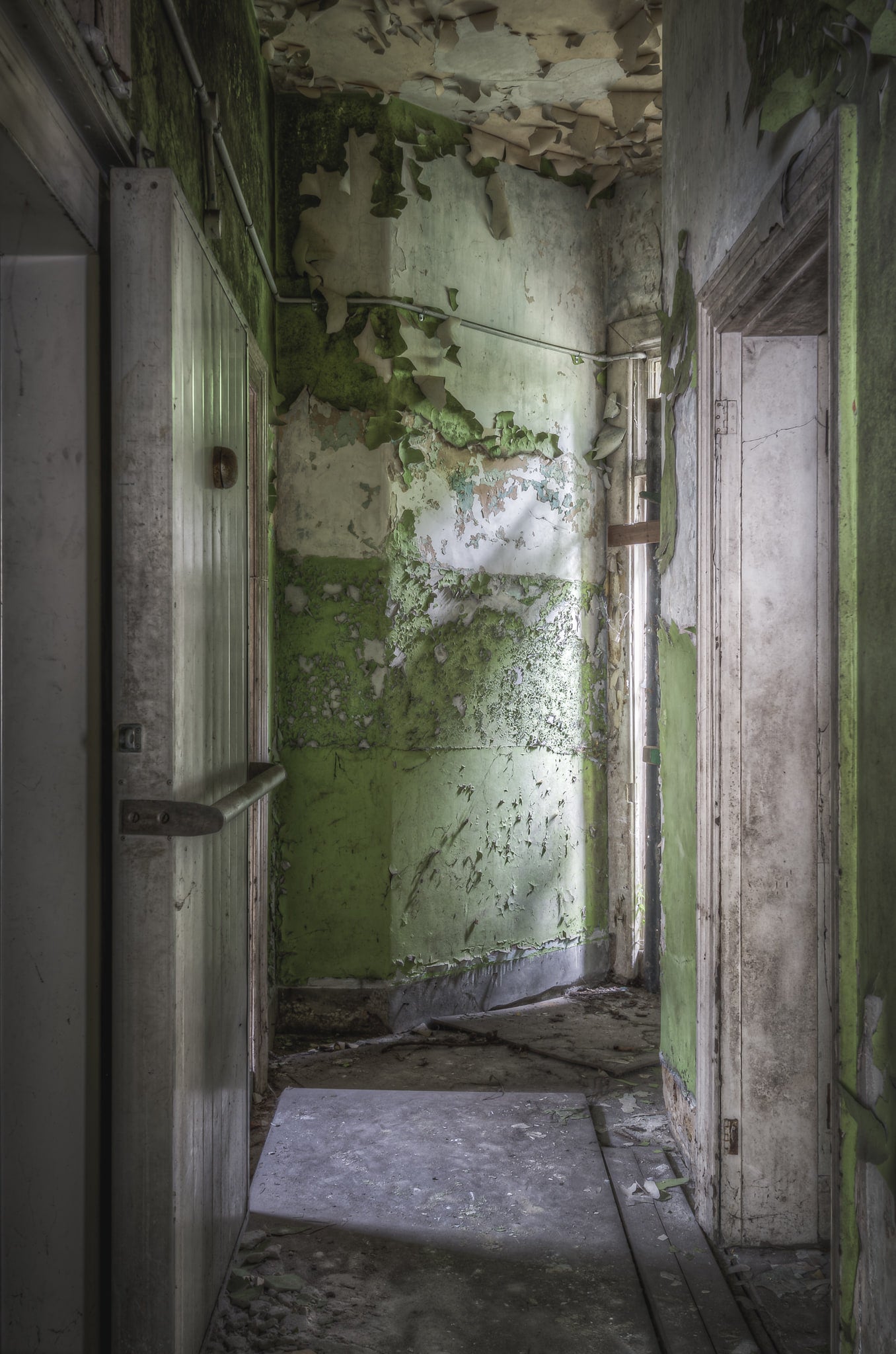 Cold Storage at Terminus Hotel, light cuts across the floor in a quiet diagonal, illuminating years of dust and decay.