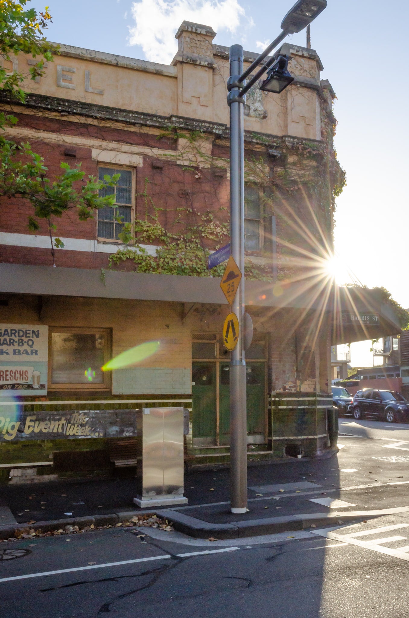 Eastern Facade at Terminus Hotel, late sun breaks hard around the corner of the Terminus Hotel, throwing a starburst.