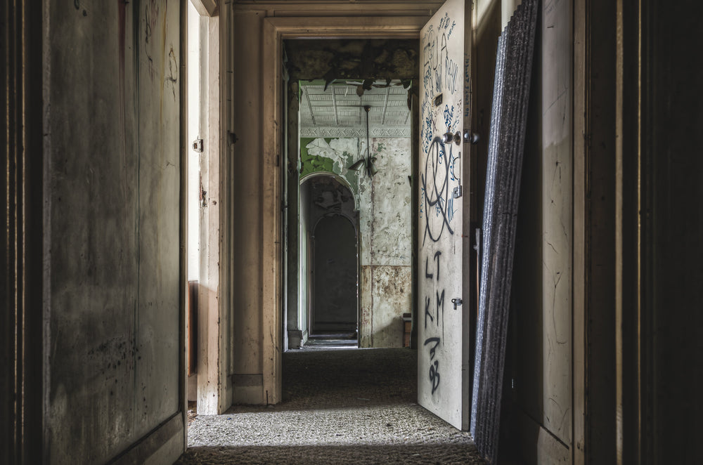Hallway From Main Guest Rooms at Terminus Hotel, a corridor recedes through successive doorways, each frame narrower than.