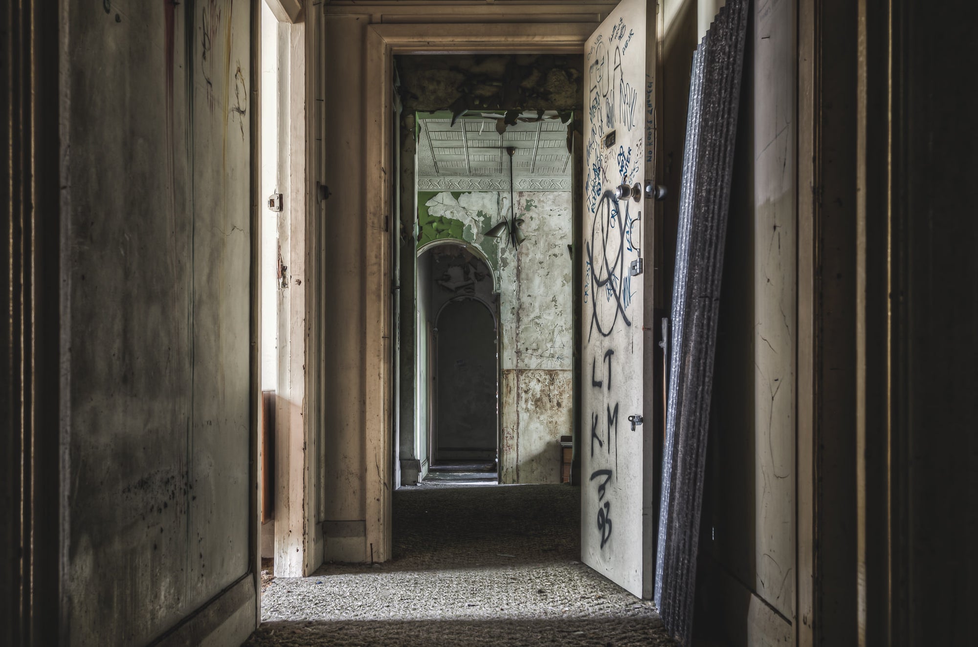 Hallway From Main Guest Rooms at Terminus Hotel, a corridor recedes through successive doorways, each frame narrower than.