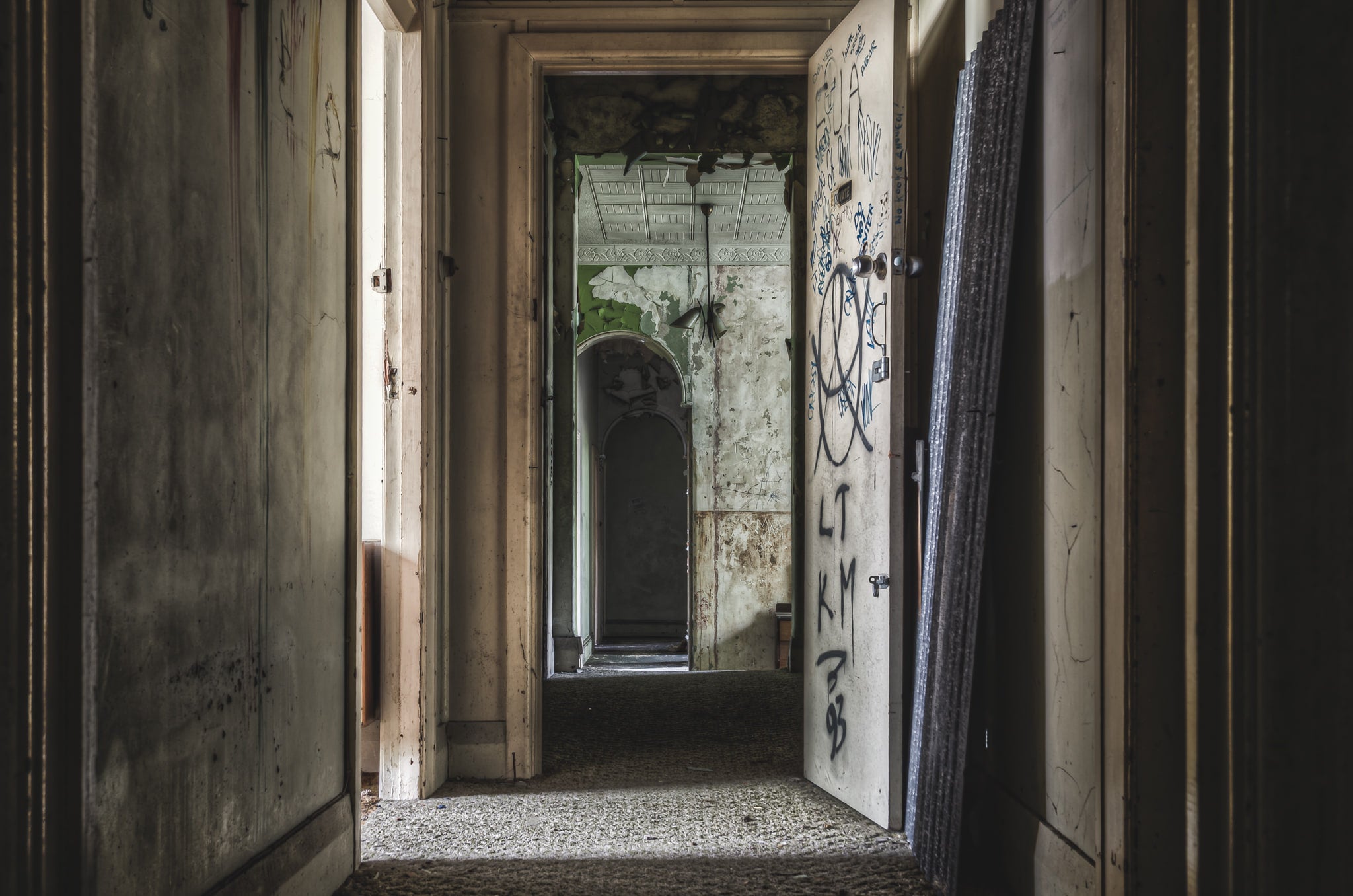 Hallway From Main Guest Rooms at Terminus Hotel, a corridor recedes through successive doorways, each frame narrower than.