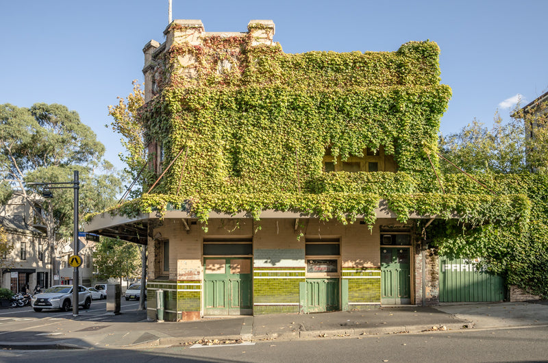 The Terminus Hotel's north facade shows layers of decay. Peeling paint and grimy windows mark the Federation brickwork, photographed in 2016 after 33 years closed.