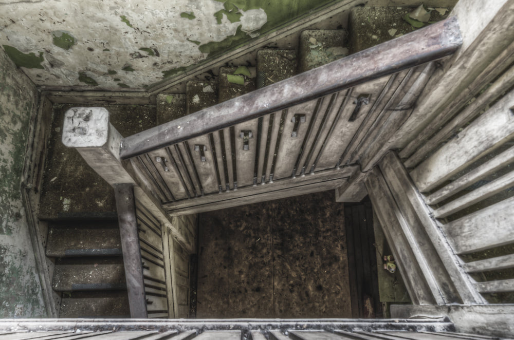 Stairwell at Terminus Hotel, looking down from the upper landing, the stairwell drops through tight right-angle turns.