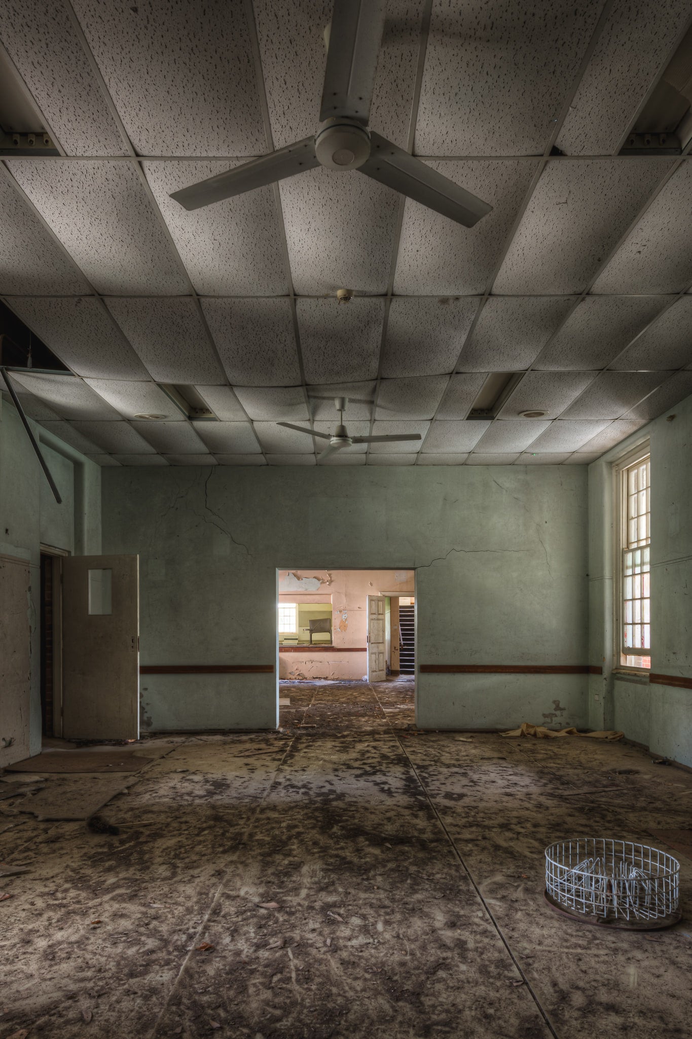 Bottleneck at The Asylum, a pale green ward opens wide and bare.