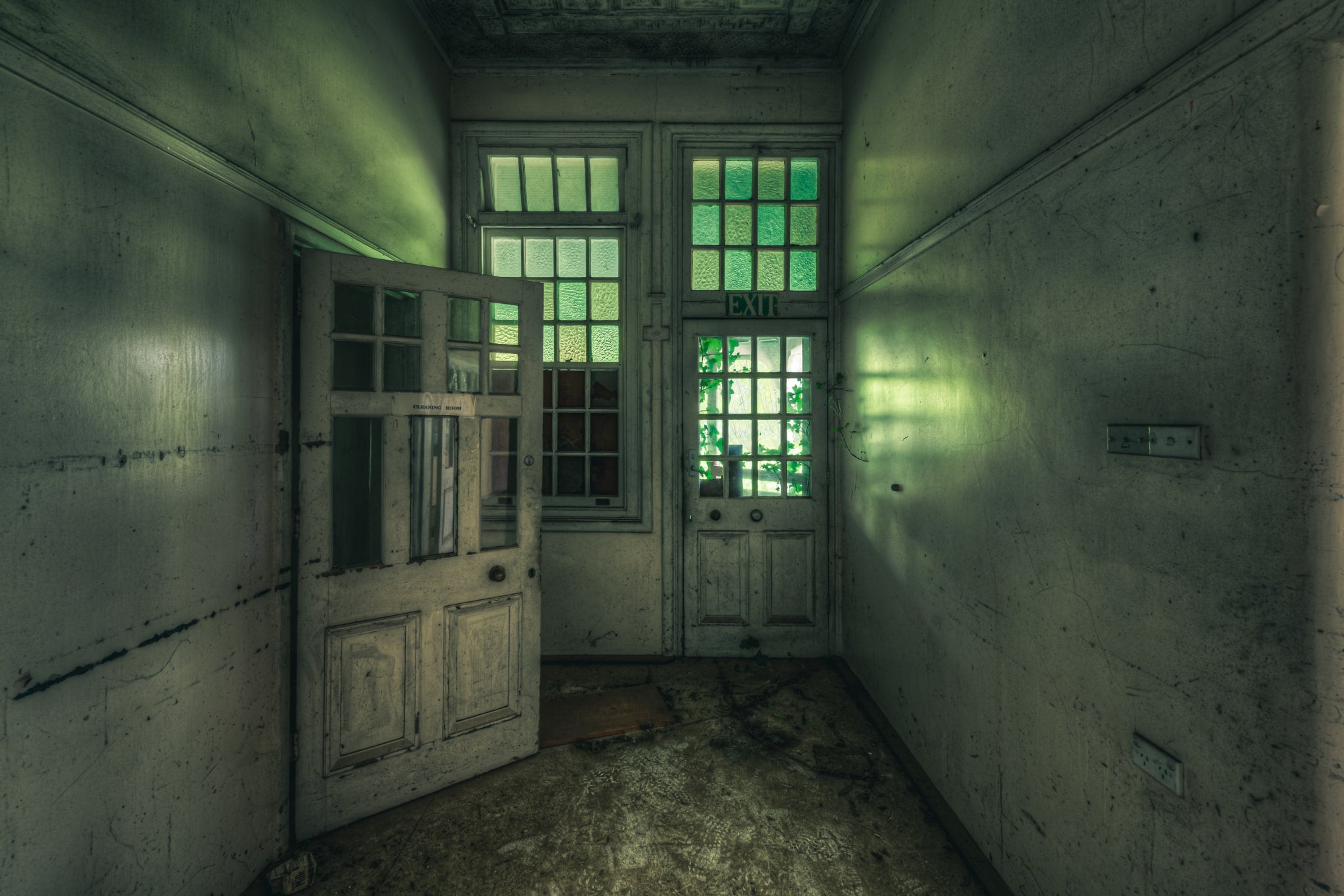 Exit at The Asylum, a narrow corridor ends at two panelled timber doors.