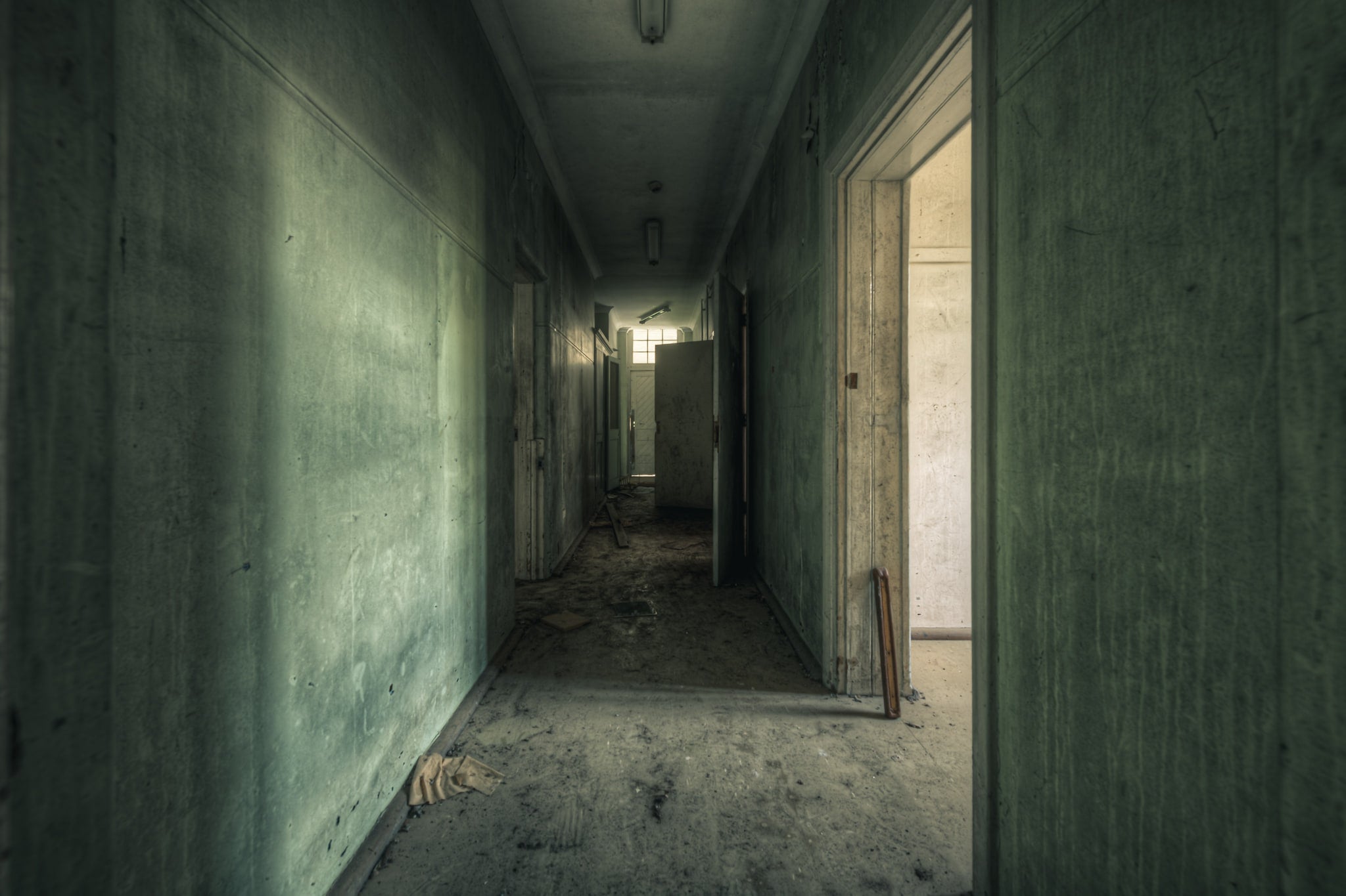 Hall of Shadows at The Asylum, a narrow corridor stretches deep into the building.