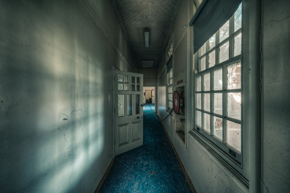 Long Blue Walk at The Asylum, a narrow corridor stretches deep into the building.