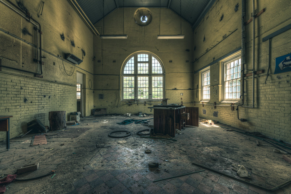 Mechanical Workshop at The Asylum, a high-ceilinged hall with a corrugated iron roof pitched to a central ridge.