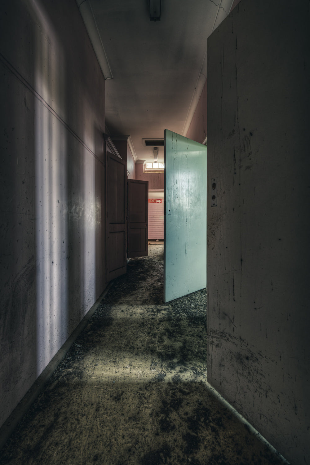 Obstacles at The Asylum, a narrow corridor, concrete walls streaked with damp.