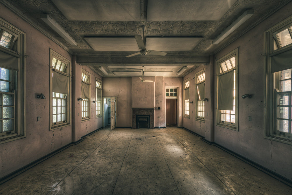 Pink Bedroom at The Asylum, a large empty room stripped back to bare plaster.