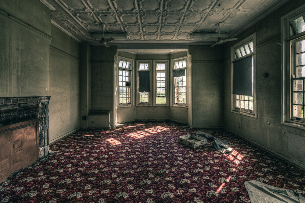 The Grand Room at The Asylum, a deep crimson and grey floral carpet covers the entire floor, still intact.