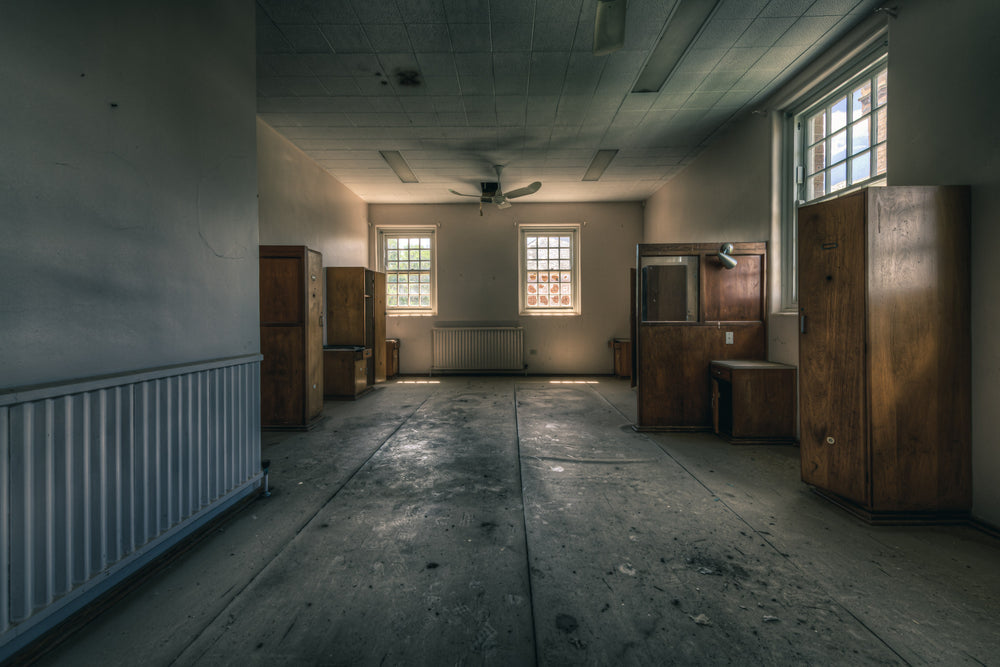 The Upstairs Corner at The Asylum, timber wardrobes line the walls of a broad, empty room.