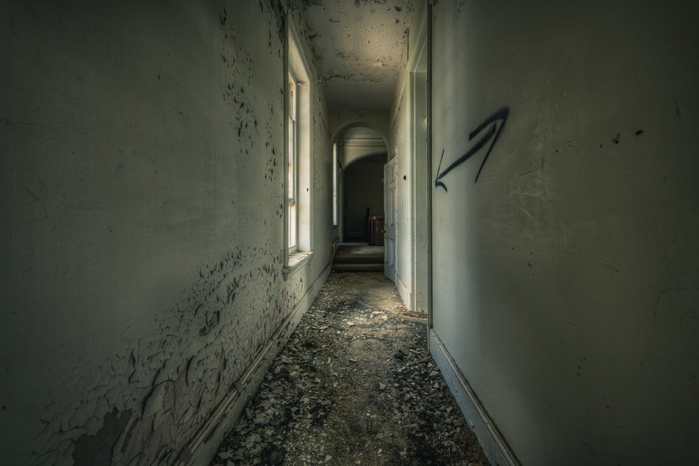 Walking on the Ceiling at The Asylum, a narrow corridor stretches deep into the building.