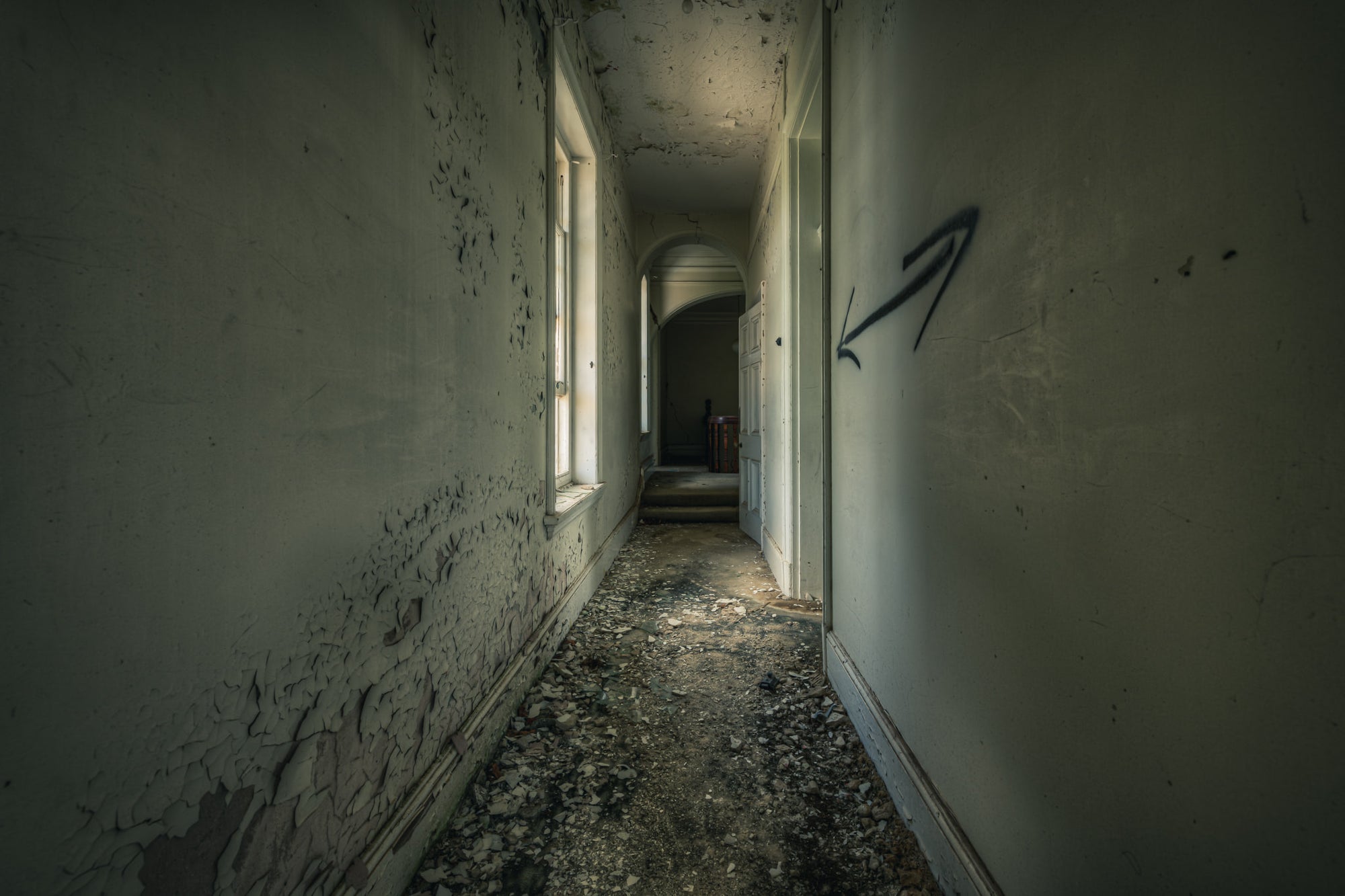 Walking on the Ceiling at The Asylum, a narrow corridor stretches deep into the building.