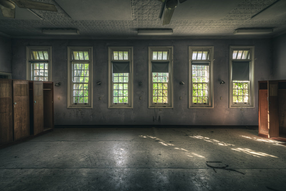 Ward Windows at The Asylum, five tall windows line the ward wall, each divided into small panes with transom lights above.
