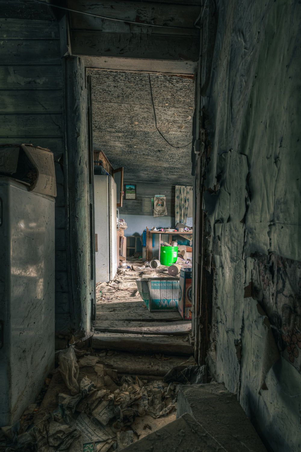 Hallway at The Post Office, a narrow hallway leads toward a cluttered room.