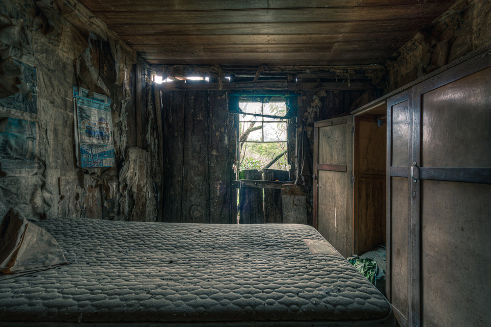 Over the Bed at The Post Office, a bare mattress fills most of the narrow room.