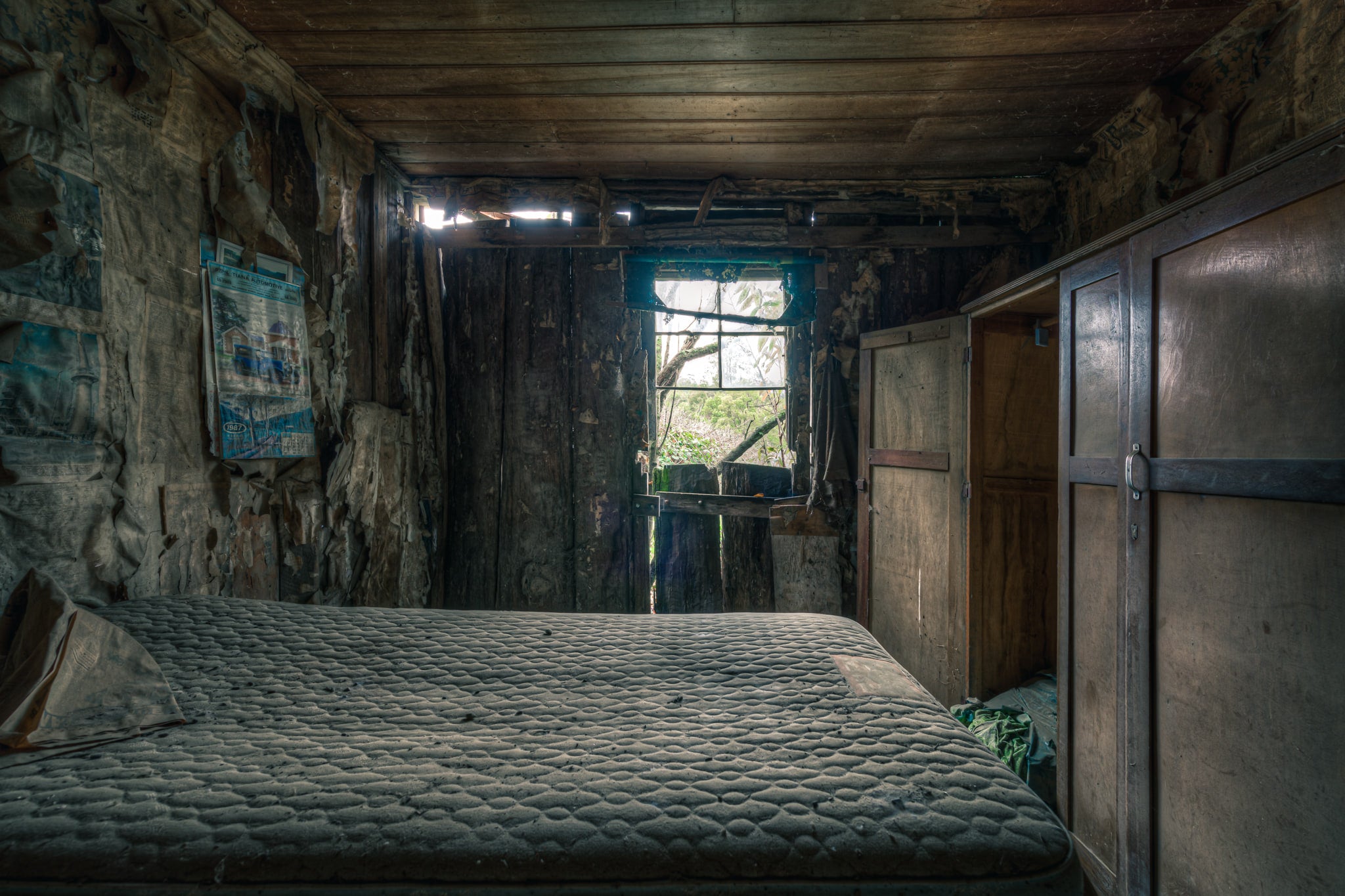 Over the Bed at The Post Office, a bare mattress fills most of the narrow room.