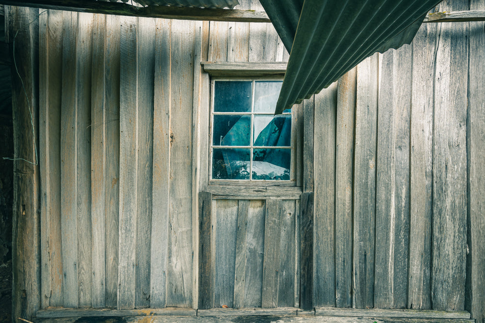 Verandah Wall at The Post Office, weathered timber boards line the corner where two walls meet at the verandah.