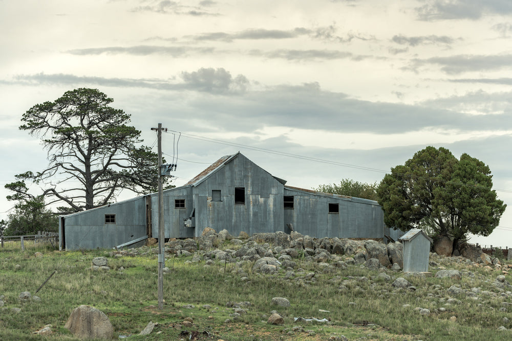 Numbla Vale Woolshed at The Woolshed, a corrugated iron woolshed perched atop a rocky crest.