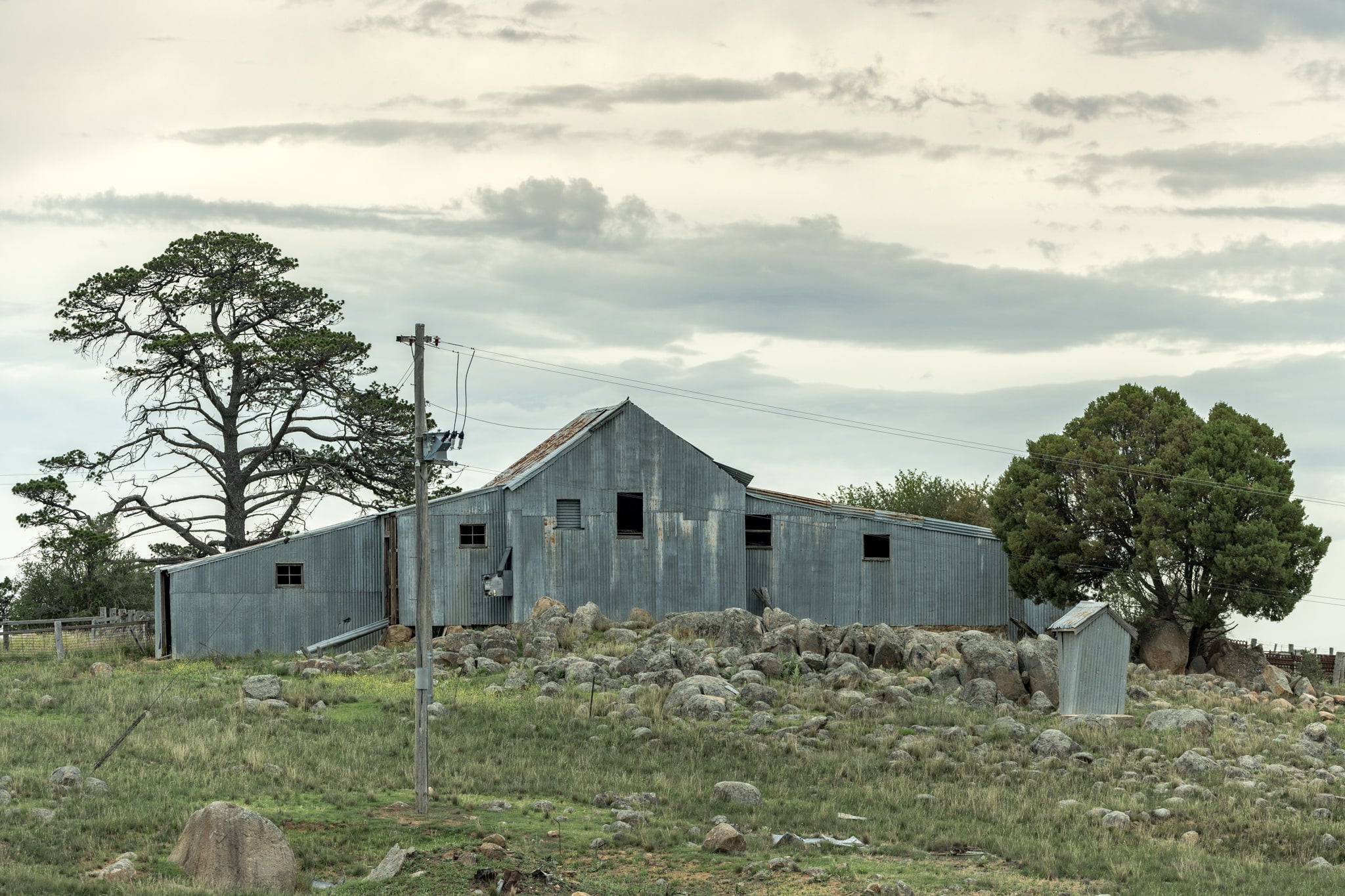 Numbla Vale Woolshed at The Woolshed, a corrugated iron woolshed perched atop a rocky crest.