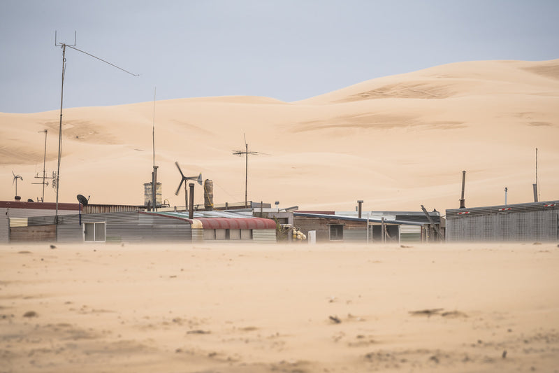 Aerials at Tin City, a low line of corrugated iron shacks sits half-buried at the base of the Stockton Dunes.